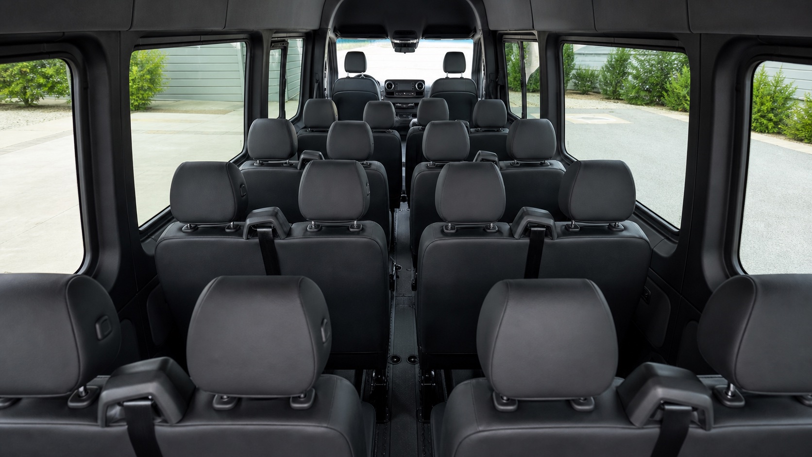 Spacious black passenger seating inside a Mercedes-Benz Sprinter 2500 High Roof